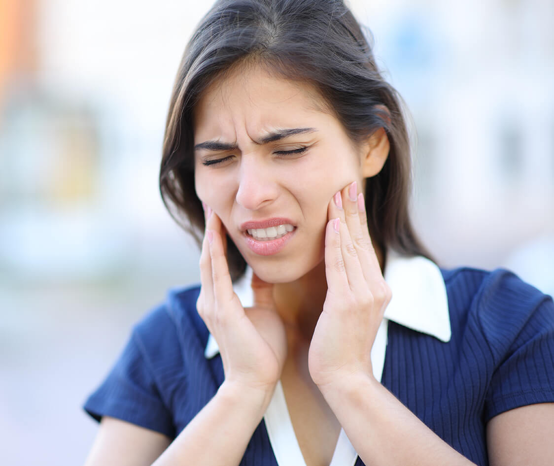 Woman suffering tmj complaining in the street